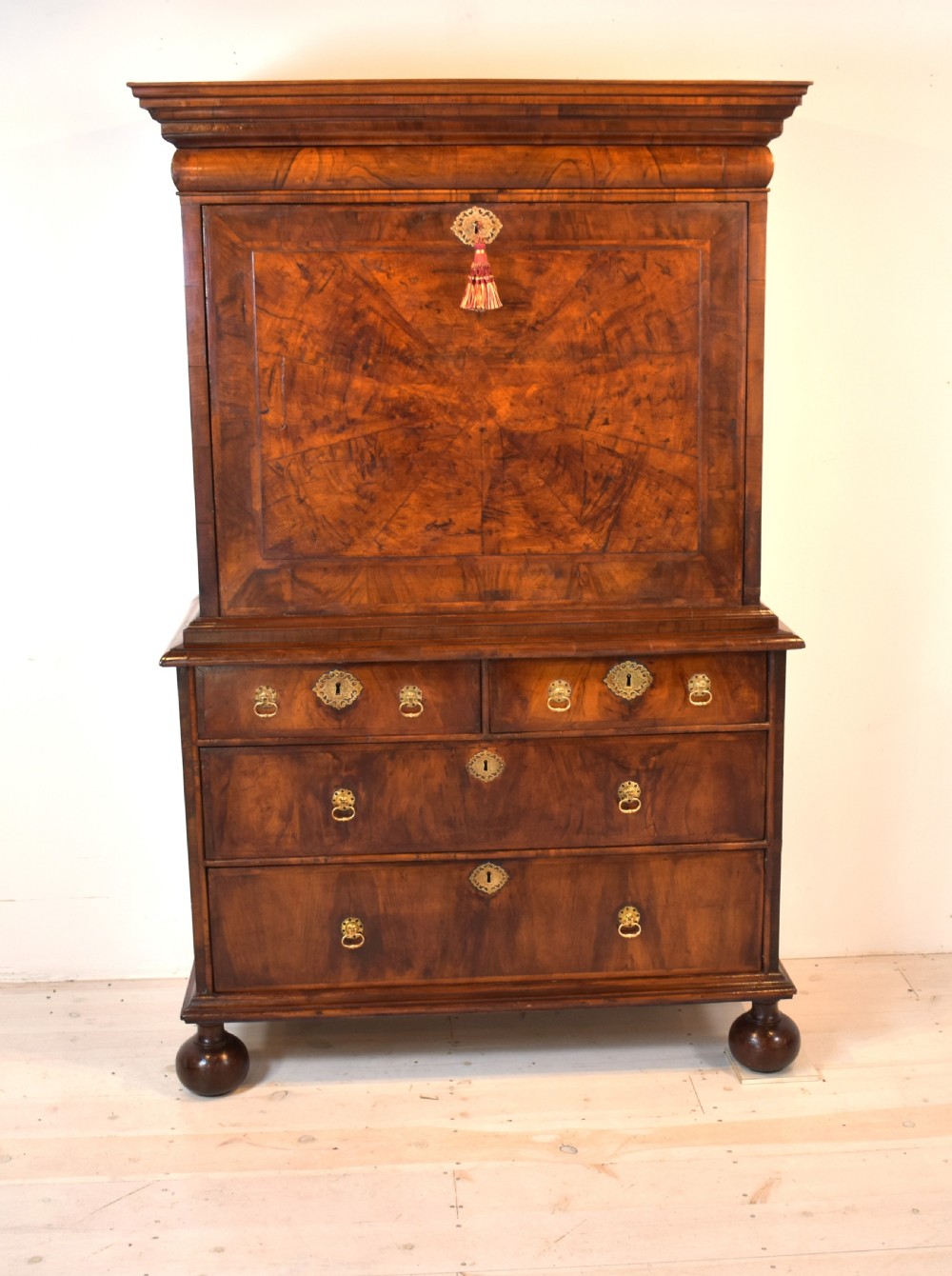 A Queen Anne walnut fall-front secretaire featuring a fitted interior with small drawers, green baize writing surface, brass drop handles, and turned bun feet. View VIII