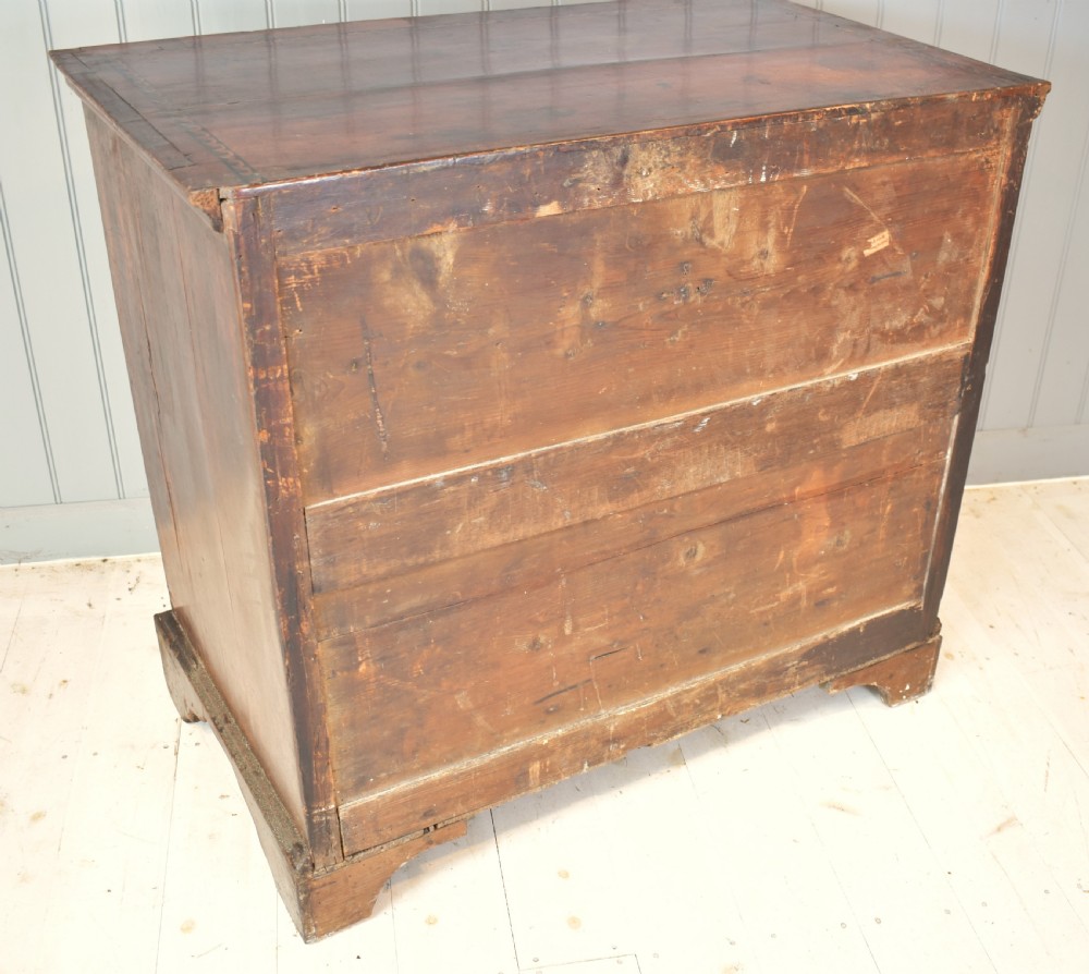 A 17th-century William and Mary walnut chest of drawers featuring intricate floral marquetry inlay, brass drop handles, decorative keyhole escutcheons, and bracket feet. View VIII