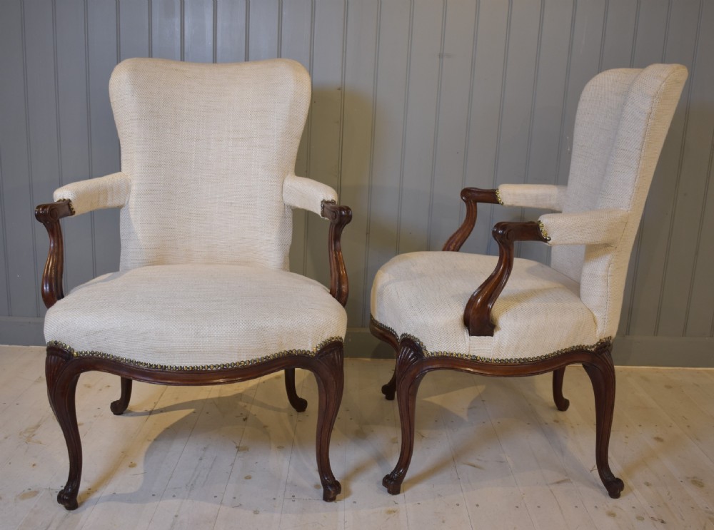 A pair of French Hepplewhite style armchairs upholstered in textured cream linen with carved dark mahogany frames and brass stud detailing. View II
