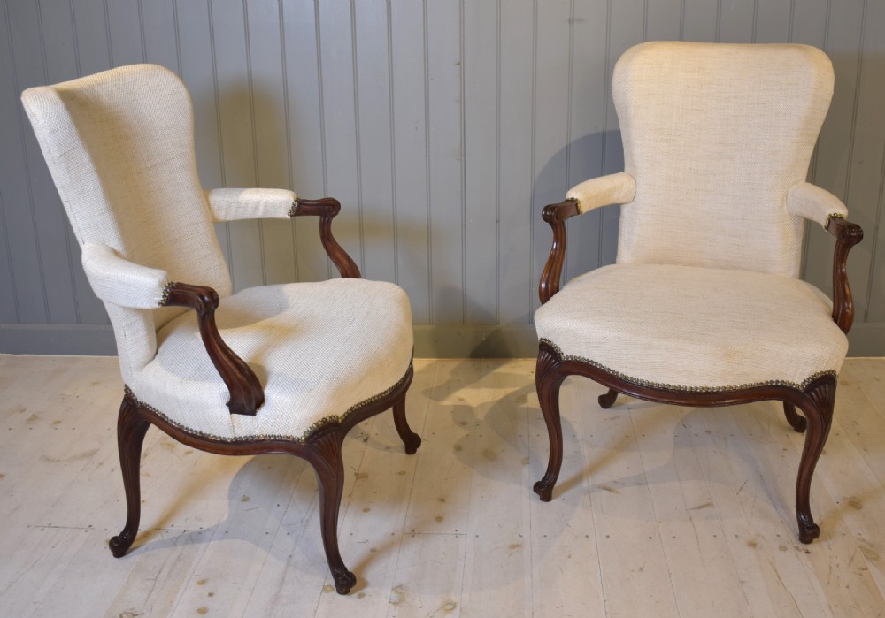 A pair of French Hepplewhite style armchairs upholstered in textured cream linen with carved dark mahogany frames and brass stud detailing. View III