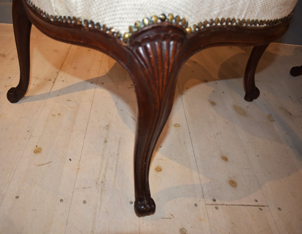 A pair of French Hepplewhite style armchairs upholstered in textured cream linen with carved dark mahogany frames and brass stud detailing. View XI