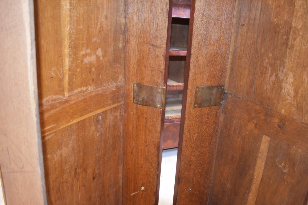 A 19th-century French Empire flame mahogany commode featuring a white marble top, three large drawers with gilt-bronze wreath handles, and flanking columns topped with ormolu accents. View IX