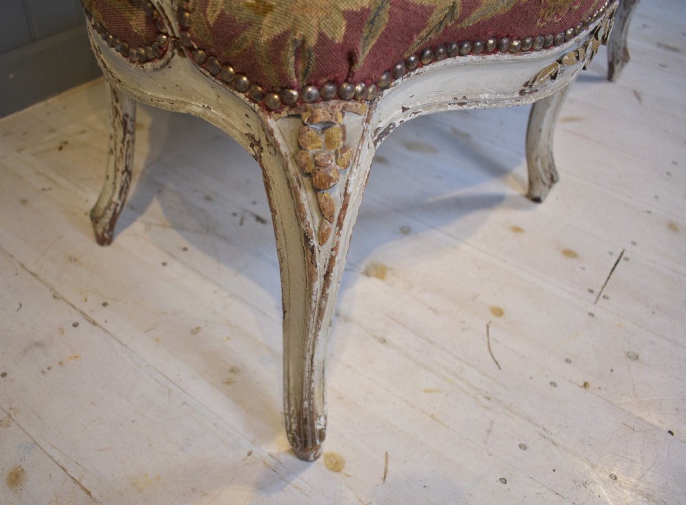 A French Louis XV style painted wooden settee with serpentine rails, cabriole legs, and woven tapestry upholstery featuring birds and palm trees. View VII