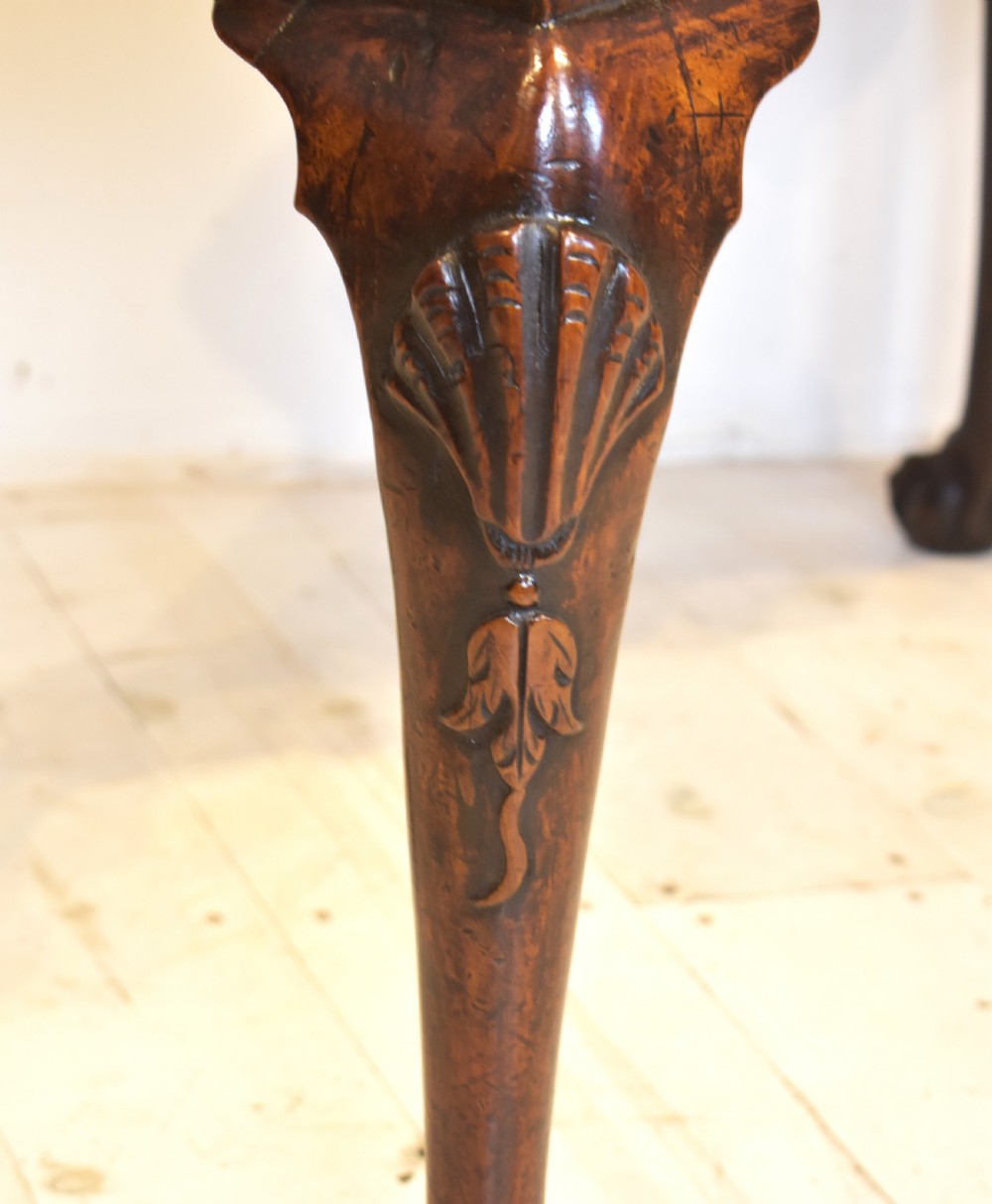 An antique Queen Anne walnut lowboy table featuring three drawers, brass handles, a shaped apron, and carved cabriole legs ending in ball and claw feet. View VI