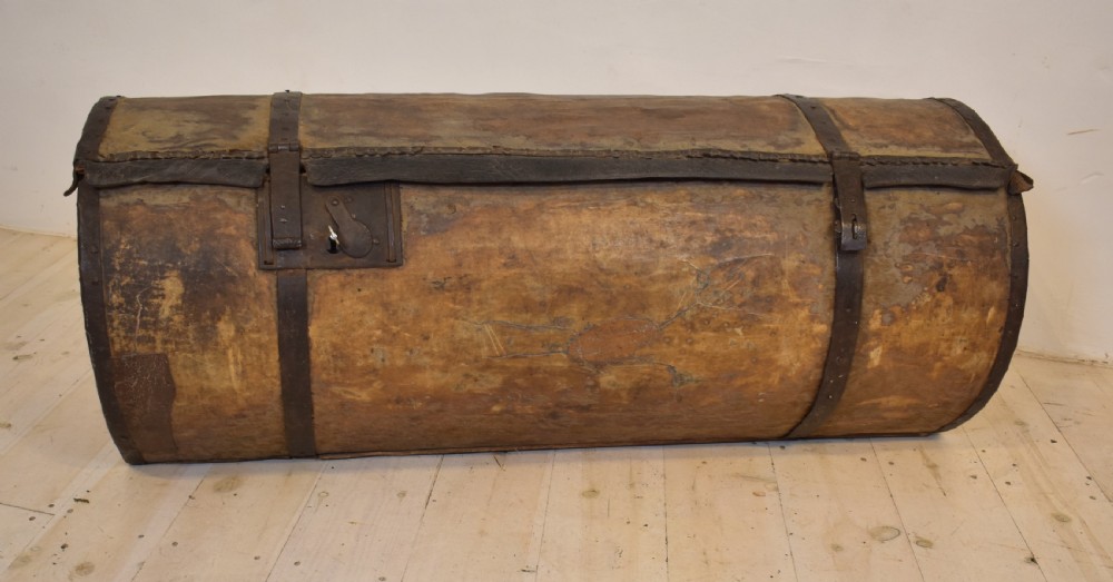 An antique cylindrical hide-covered coffer bound with dark leather trim and heavy iron bands with side handles. View VIII