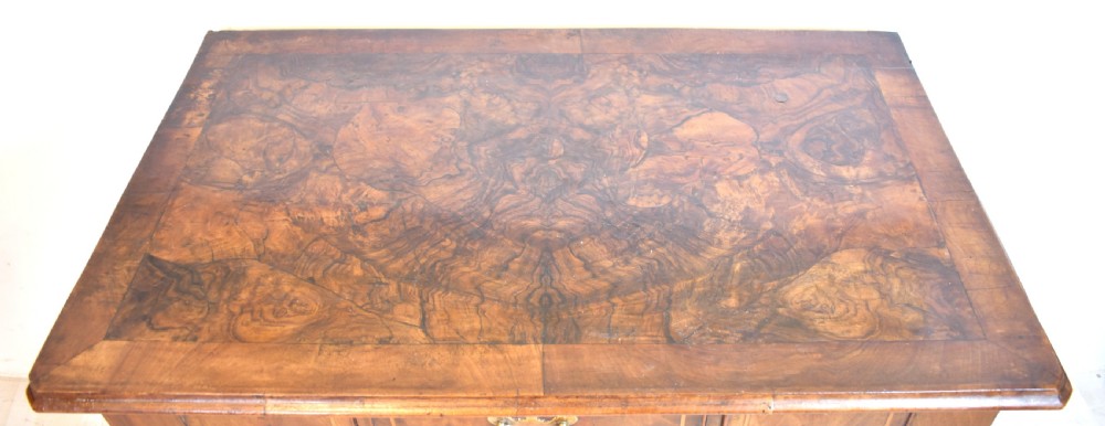 An antique Queen Anne style walnut lowboy featuring three crossbanded drawers with brass drop handles, a scalloped apron, and slender cabriole legs. View II