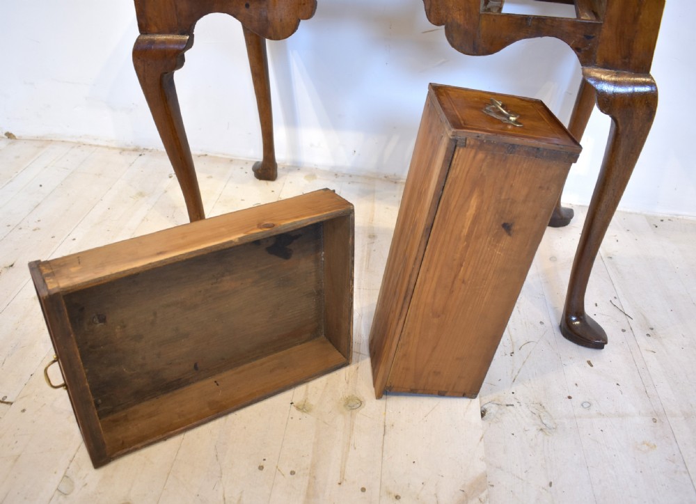 An antique Queen Anne style walnut lowboy featuring three crossbanded drawers with brass drop handles, a scalloped apron, and slender cabriole legs. View III