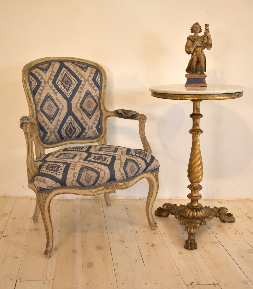 An antique giltwood tripod side table featuring a circular white marble top supported by a spiral twist column and three carved paw feet. View III