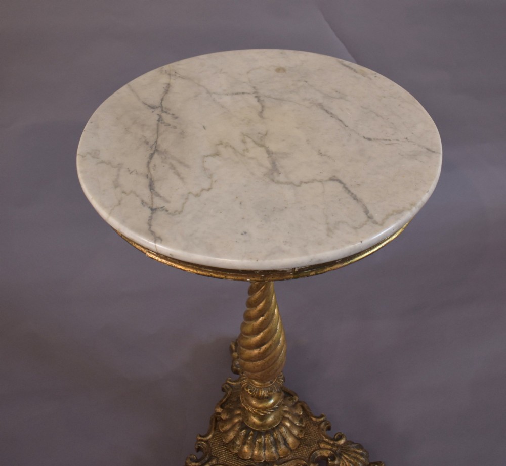 An antique giltwood tripod side table featuring a circular white marble top supported by a spiral twist column and three carved paw feet. View V