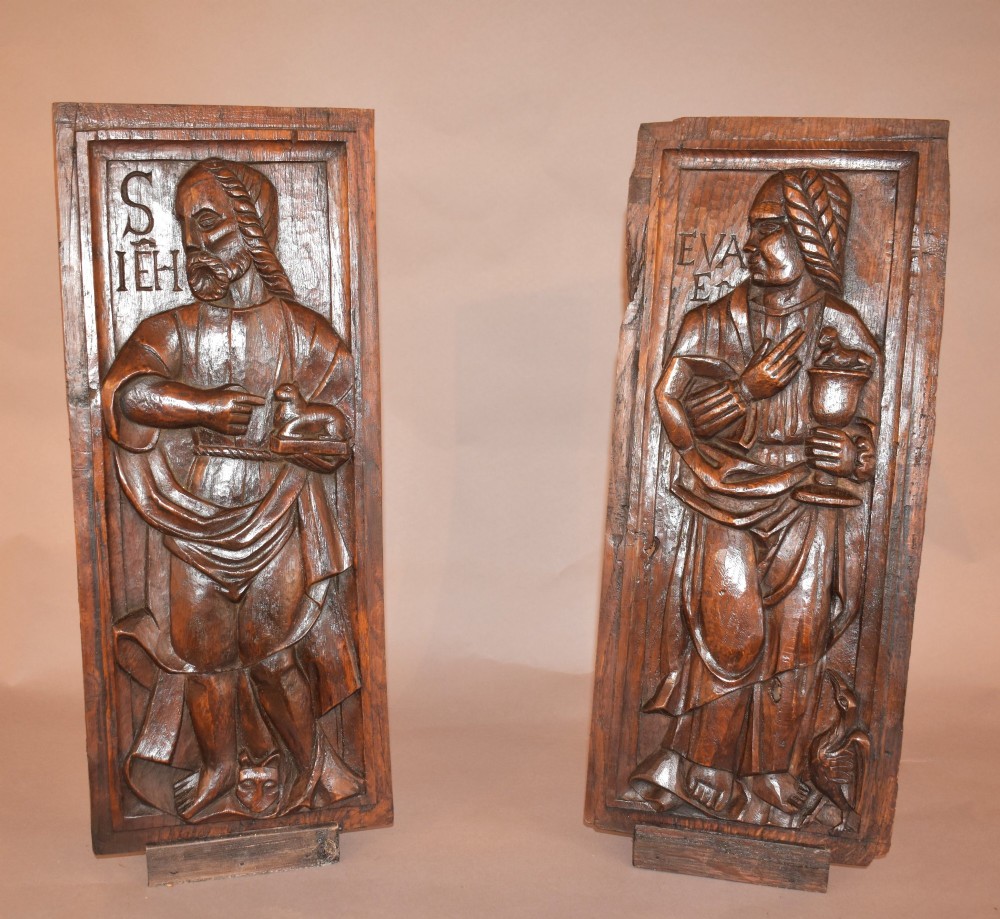 A pair of 17th-century rectangular dark oak timber panels featuring hand-carved relief figures of saints with Latin inscriptions. View II