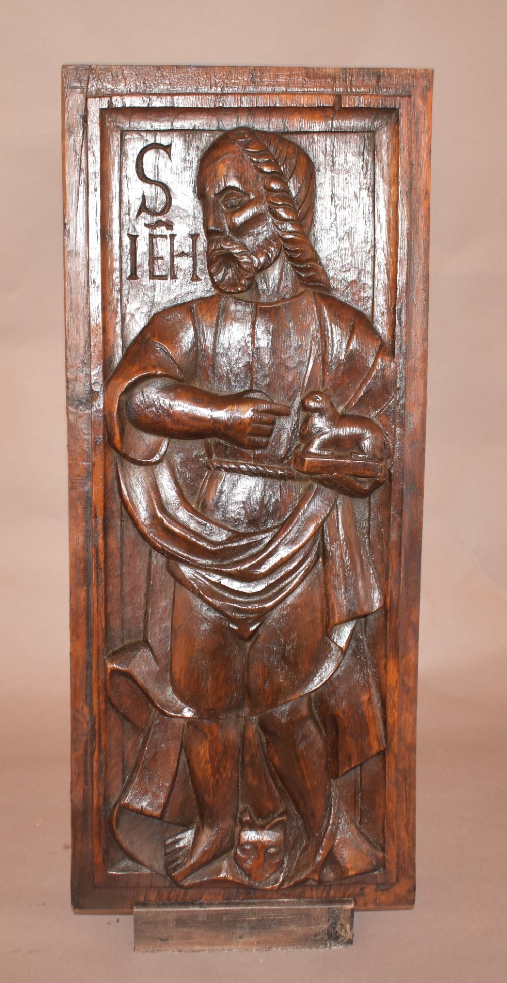 A pair of 17th-century rectangular dark oak timber panels featuring hand-carved relief figures of saints with Latin inscriptions. View V