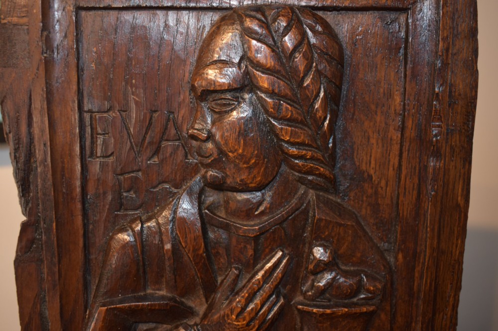 A pair of 17th-century rectangular dark oak timber panels featuring hand-carved relief figures of saints with Latin inscriptions. View IX