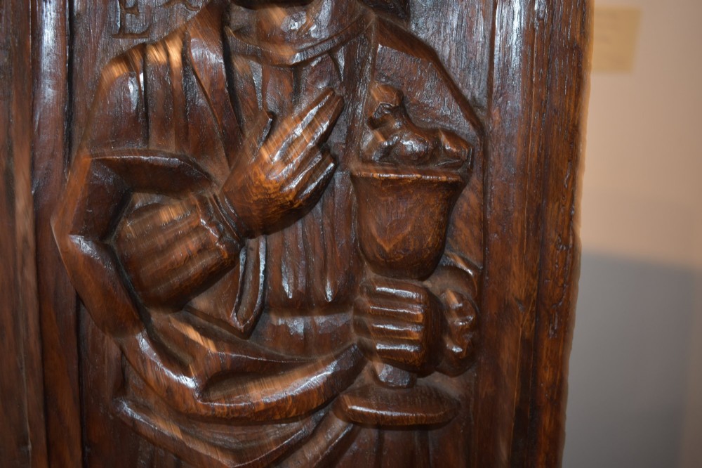 A pair of 17th-century rectangular dark oak timber panels featuring hand-carved relief figures of saints with Latin inscriptions. View XI