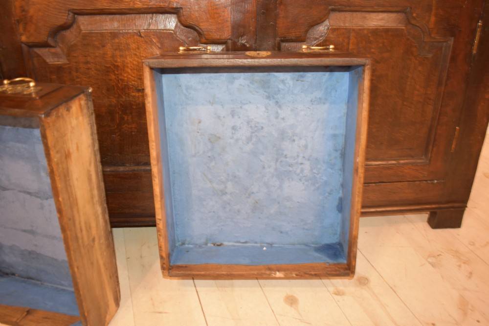 An 18th-century dark oak dresser base featuring three top drawers with brass handles above three cupboard doors with shaped fielded panels. View IX
