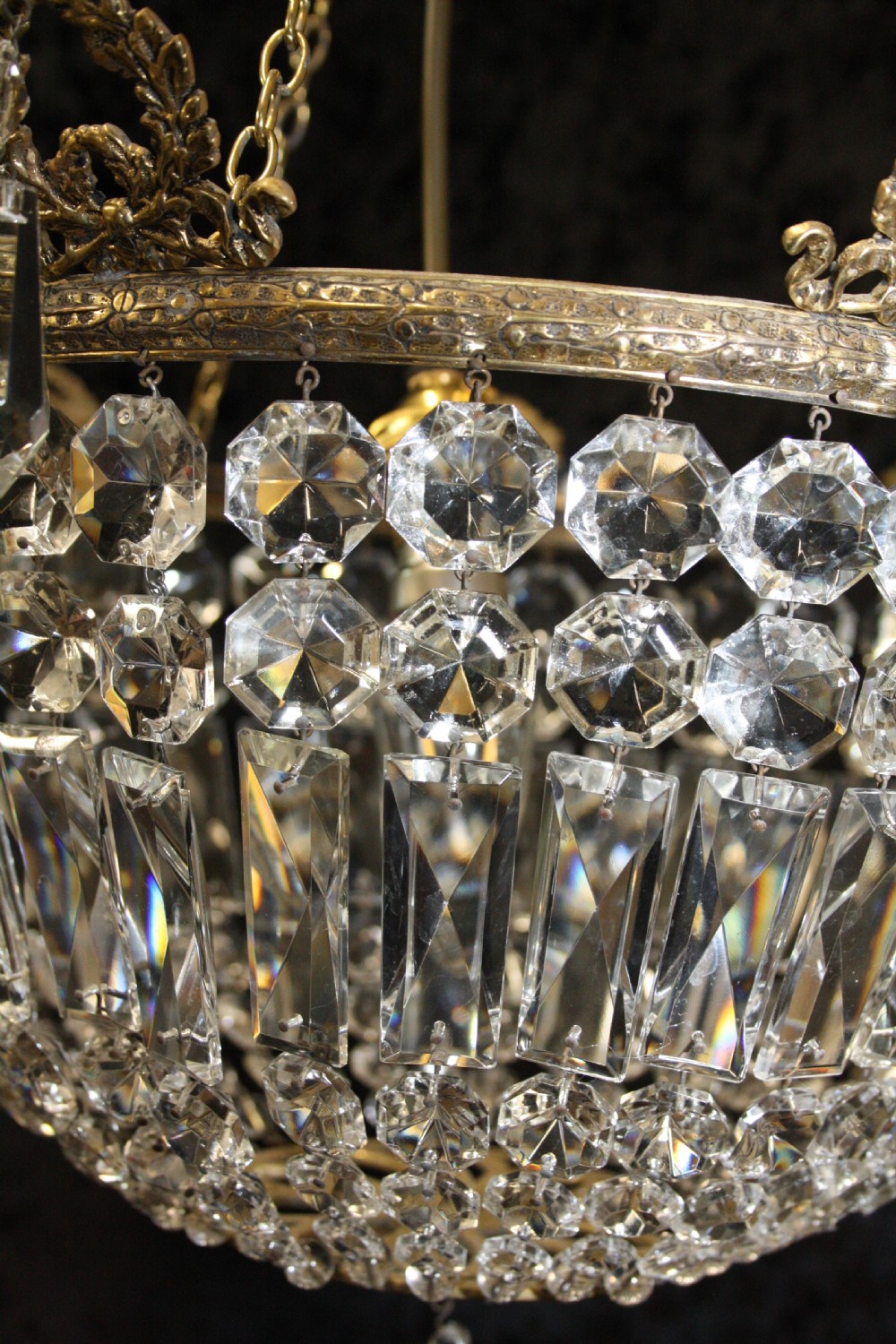 Bag chandelier with leaf decoration around the top. View V
