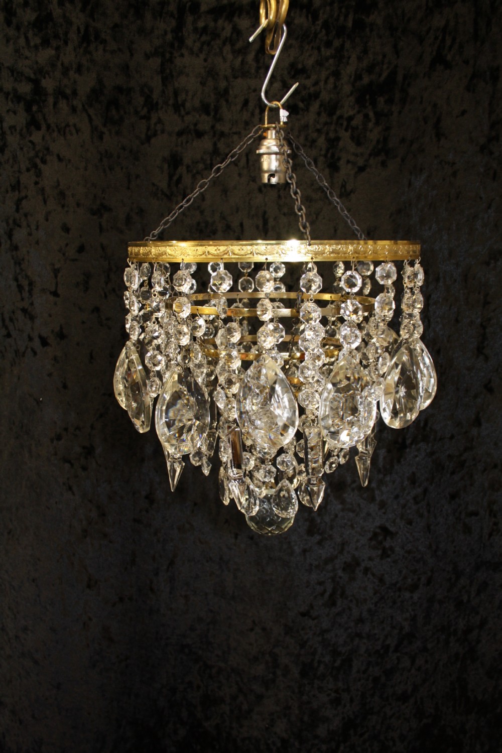 Gilt brass chandelier with unusually large drips to the top.