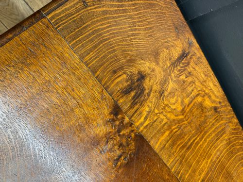 fig 2. An antique carved oak side table featuring turned legs, a single carved drawer with brass handles, and lower stretchers.
