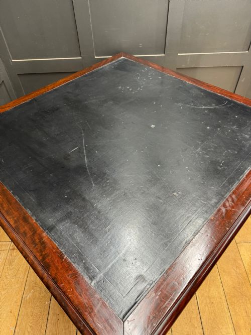 fig 3. A dark mahogany partners desk with fluted turned legs, panelled sides, and multiple drawers fitted with brass handles.