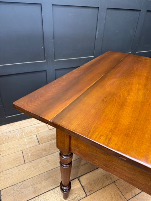 fig 2. A Victorian mahogany writing table featuring two front drawers with wooden turned knobs, four turned legs, and a drop-leaf panel.