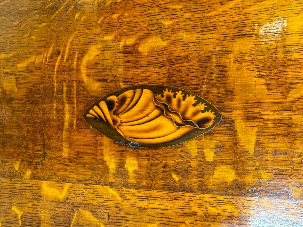 A Georgian oak wall corner cupboard featuring a single panel door with central shell marquetry inlay, crossbanded borders, and dentil moulding along the top cornice. View III