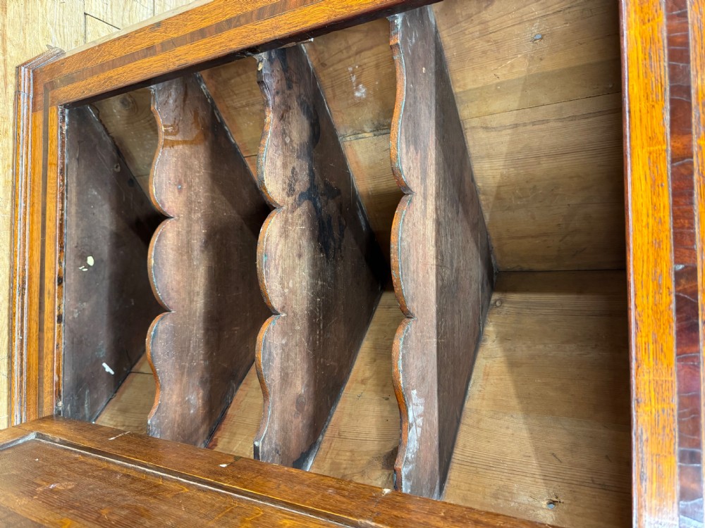 A Georgian oak wall corner cupboard featuring a single panel door with central shell marquetry inlay, crossbanded borders, and dentil moulding along the top cornice. View IV