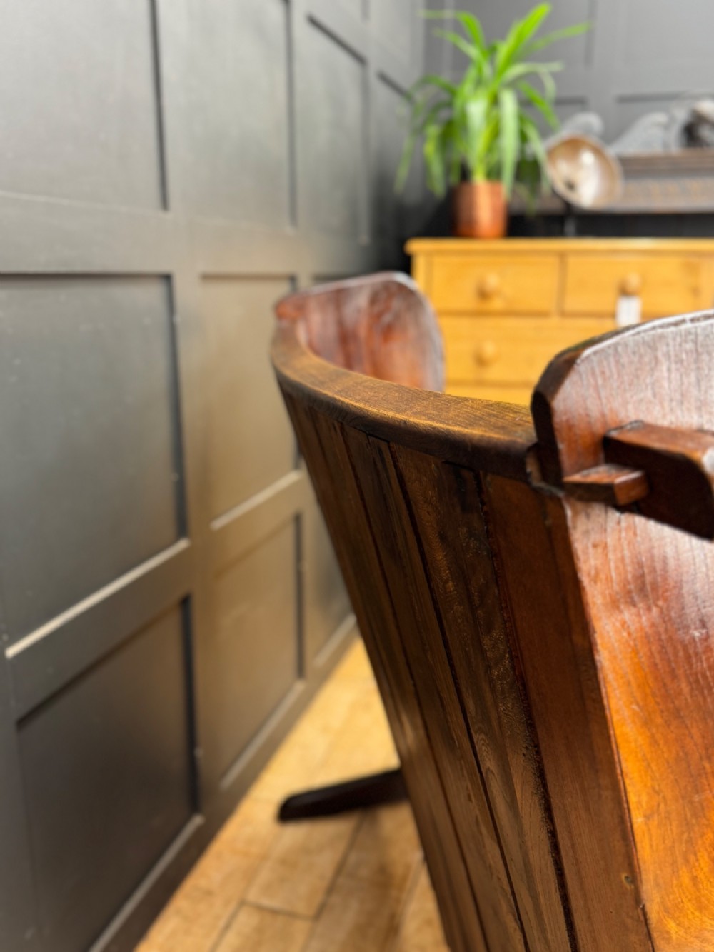 A curved antique elm wooden settle pew featuring a slatted high back, shaped side wings, and visible pegged joinery. View IX
