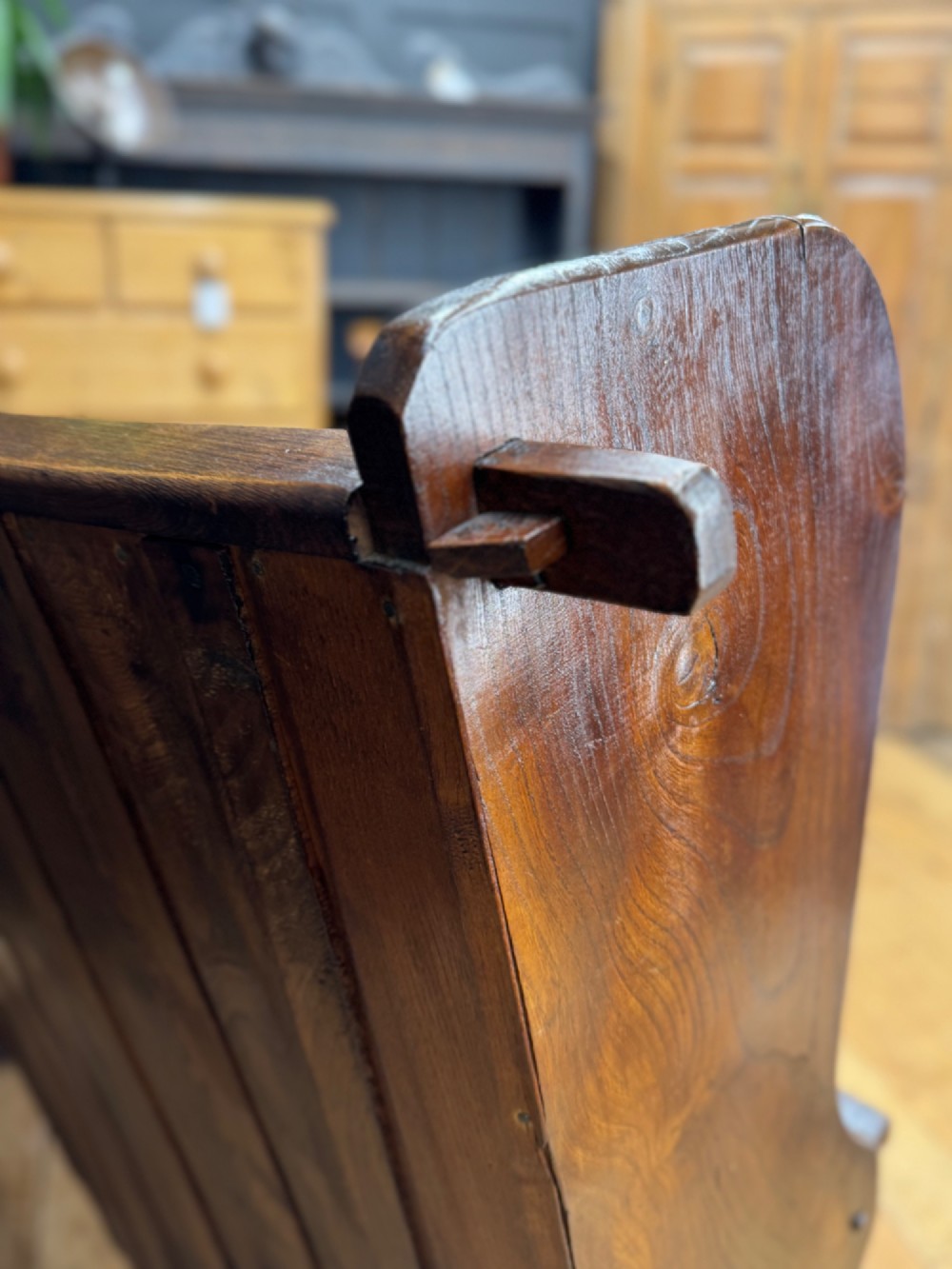 A curved antique elm wooden settle pew featuring a slatted high back, shaped side wings, and visible pegged joinery. View XI