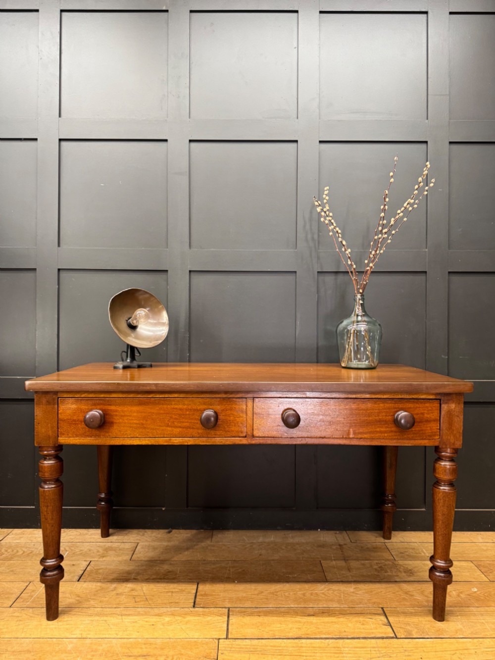 A Victorian mahogany writing table featuring two front drawers with wooden turned knobs, four turned legs, and a drop-leaf panel. View VII
