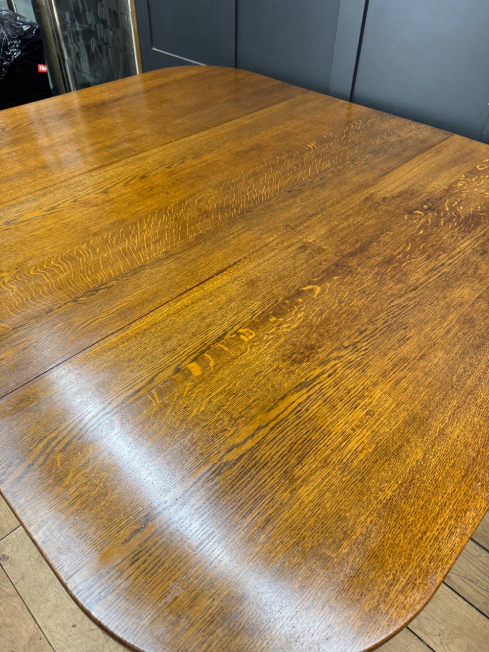 An Edwardian solid oak gateleg dining table with fully extended drop leaves, turned baluster legs, and lower stretchers. View VI