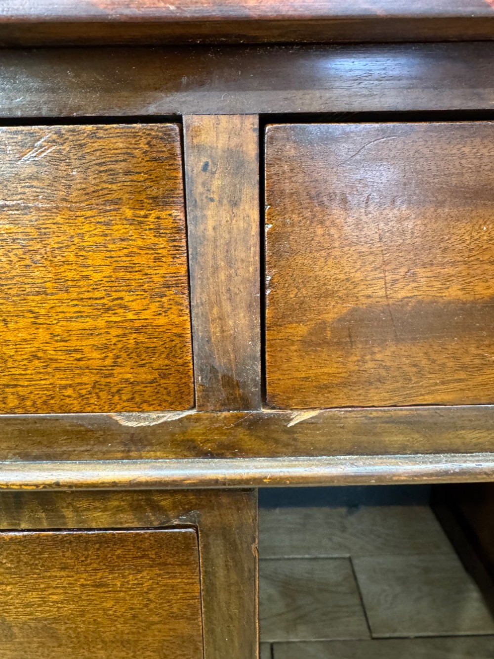 An antique mahogany pedestal desk featuring three frieze drawers, twin drawer pedestals with brass drop handles, and a solid plinth base. View II