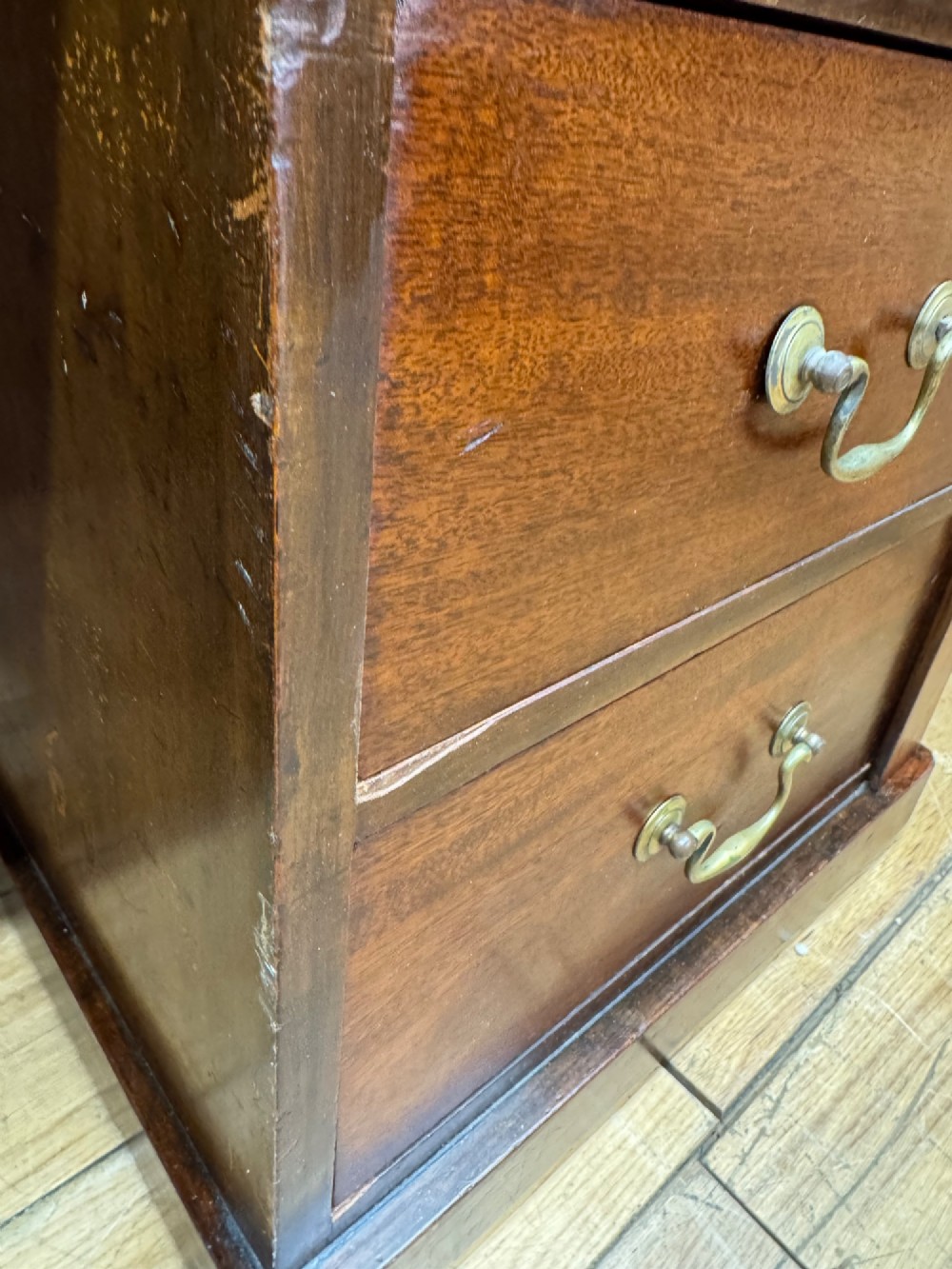 An antique mahogany pedestal desk featuring three frieze drawers, twin drawer pedestals with brass drop handles, and a solid plinth base. View III