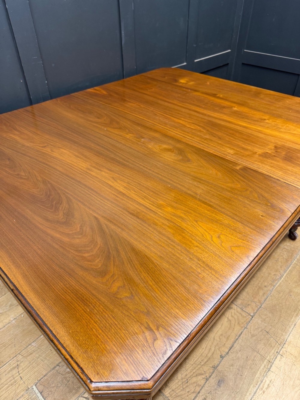A solid walnut Victorian extending dining table with reeded turned legs set on brass castors. View V