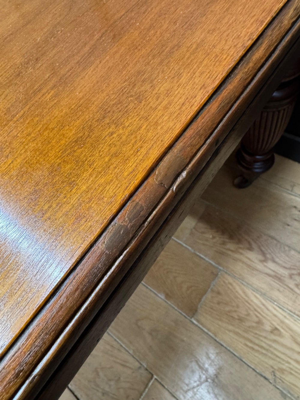 A solid walnut Victorian extending dining table with reeded turned legs set on brass castors. View VIII