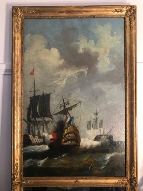 fig 5. A tall rectangular French trumeau mirror with a gilded frame containing an upper oil painting of a naval seascape and a lower mirror glass section.
