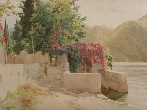 fig 2. A framed Edwardian watercolour painting depicting a sunny Lake Como shore with lush green trees, stone steps, and distant mountains enclosed in an ornate gold gilt frame.