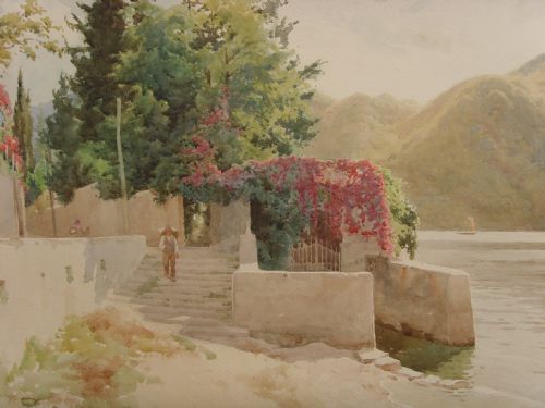 fig 1. A framed Edwardian watercolour painting depicting a sunny Lake Como shore with lush green trees, stone steps, and distant mountains enclosed in an ornate gold gilt frame.