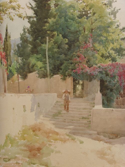 fig 2. A framed Edwardian watercolour painting depicting a sunny Lake Como shore with lush green trees, stone steps, and distant mountains enclosed in an ornate gold gilt frame.