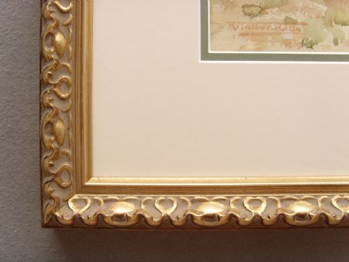 fig 6. A framed Edwardian watercolour painting depicting a sunny Lake Como shore with lush green trees, stone steps, and distant mountains enclosed in an ornate gold gilt frame.