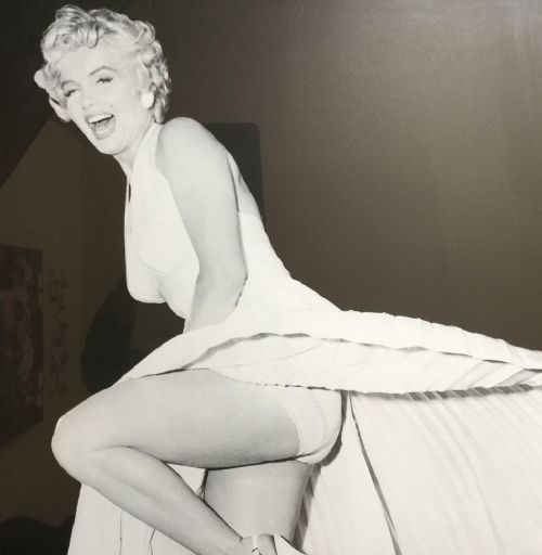 fig 4. A large black-and-white framed photographic print depicting Marilyn Monroe in a full-length portrait pose.