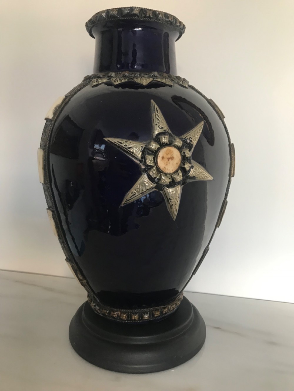 A cobalt blue glazed terracotta vase featuring silver-tone metal mounts, bone inlay strips, a star motif, and a black base. View II