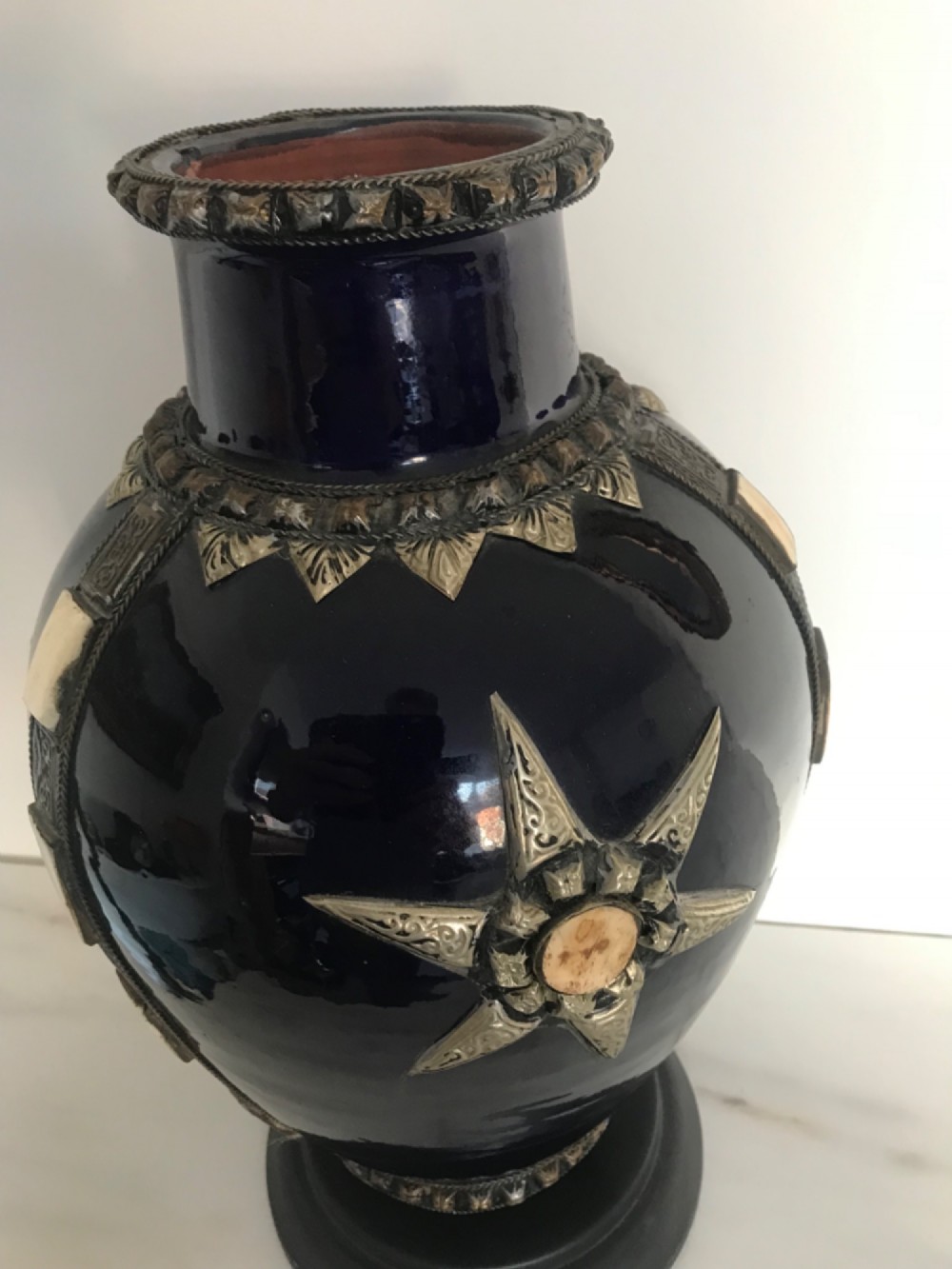 A cobalt blue glazed terracotta vase featuring silver-tone metal mounts, bone inlay strips, a star motif, and a black base. View V
