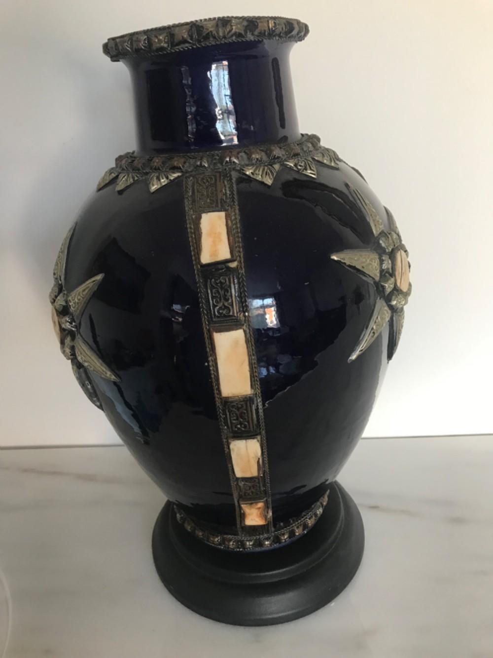A cobalt blue glazed terracotta vase featuring silver-tone metal mounts, bone inlay strips, a star motif, and a black base. View VI