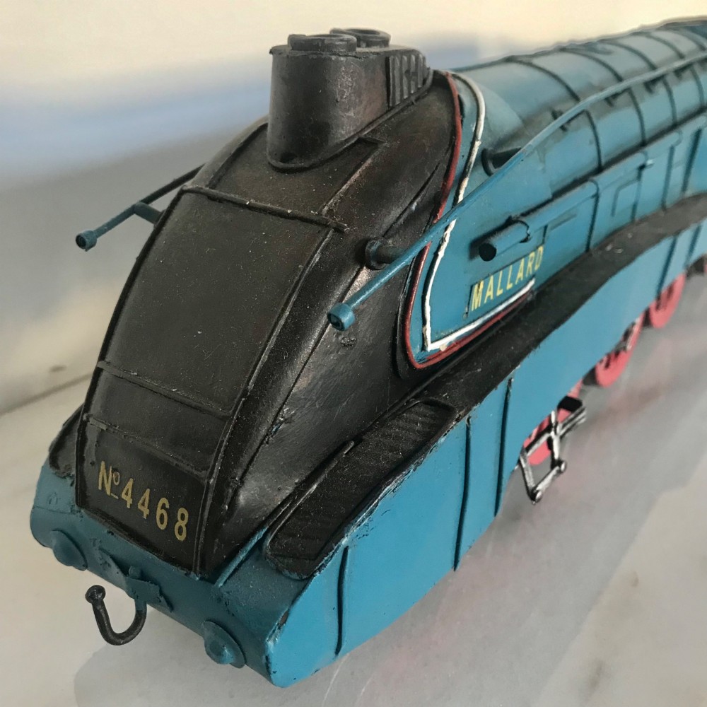 A garter blue LNER Class A4 Mallard O gauge model steam locomotive and matching coal tender with yellow lettering and red spoked wheels. View IV