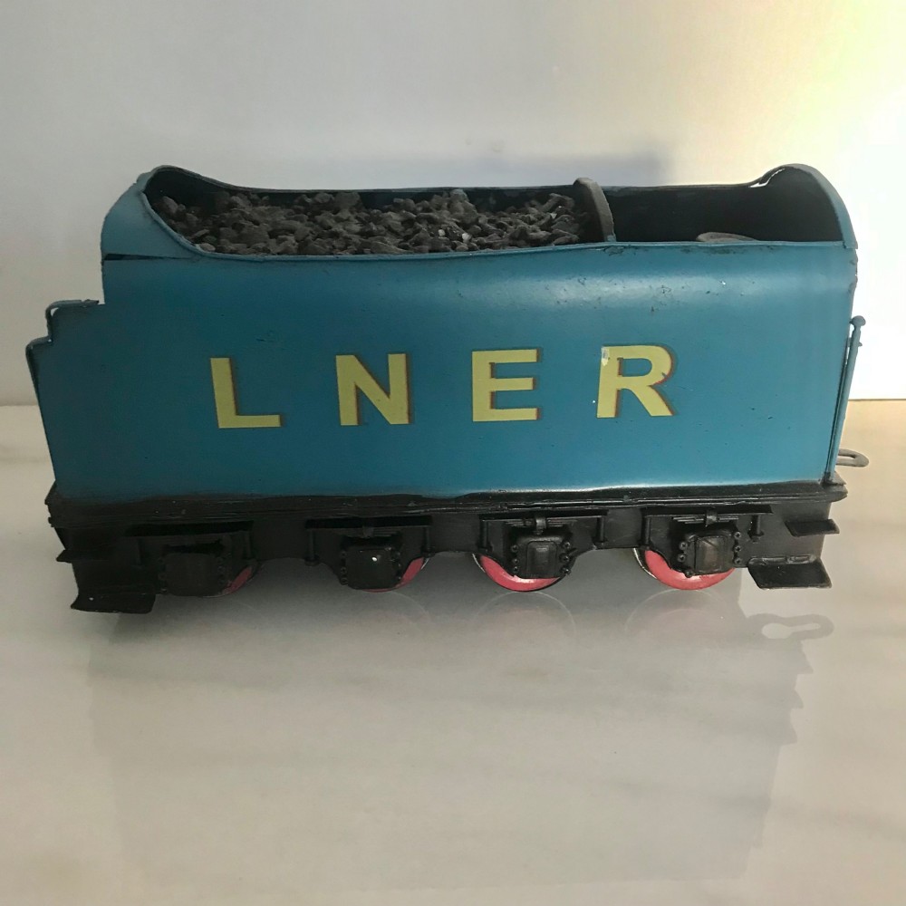 A garter blue LNER Class A4 Mallard O gauge model steam locomotive and matching coal tender with yellow lettering and red spoked wheels. View V