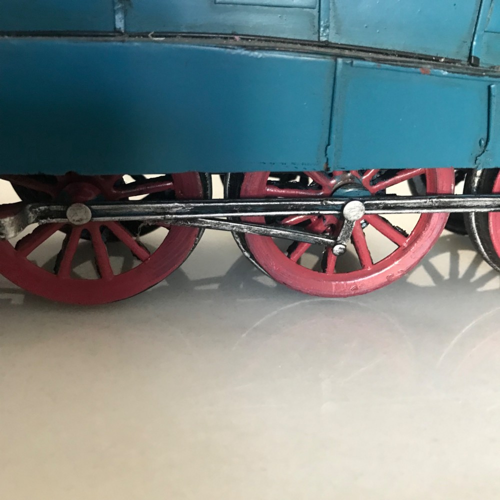 A garter blue LNER Class A4 Mallard O gauge model steam locomotive and matching coal tender with yellow lettering and red spoked wheels. View IX