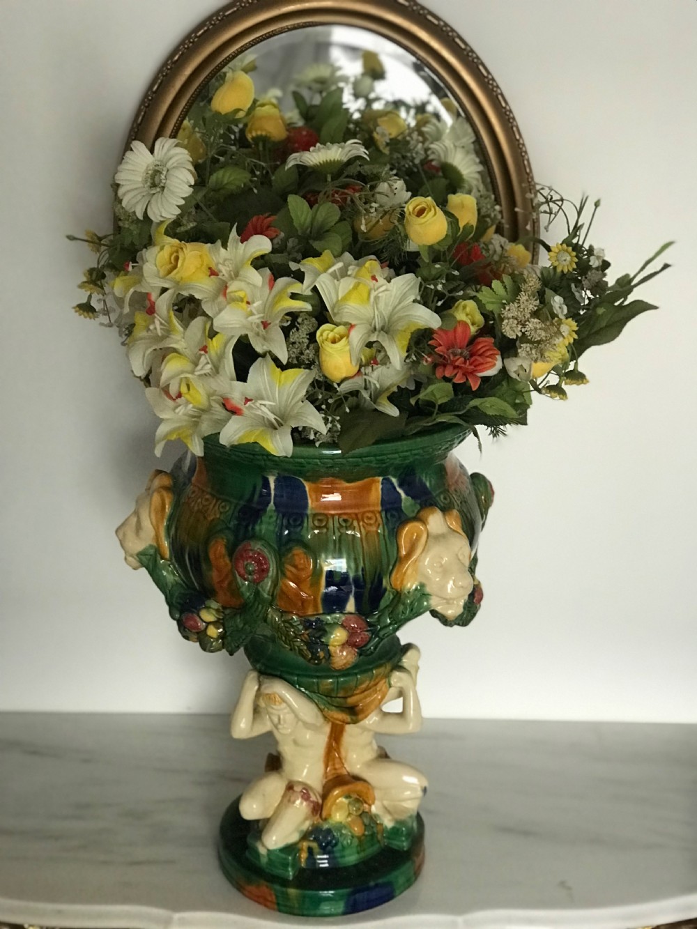 A large Italian majolica ceramic planter decorated with lion head masks and fruit garlands, resting on a sculpted figural base. View XIII