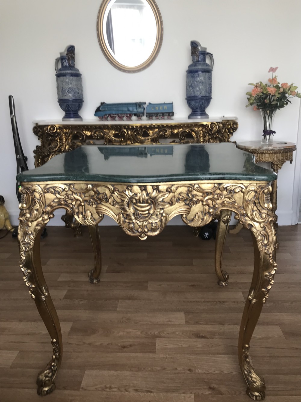 A French Rococo Revival style occasional table with a serpentine green marble top supported by an ornate gilded frame with carved cabriole legs. View XVIII