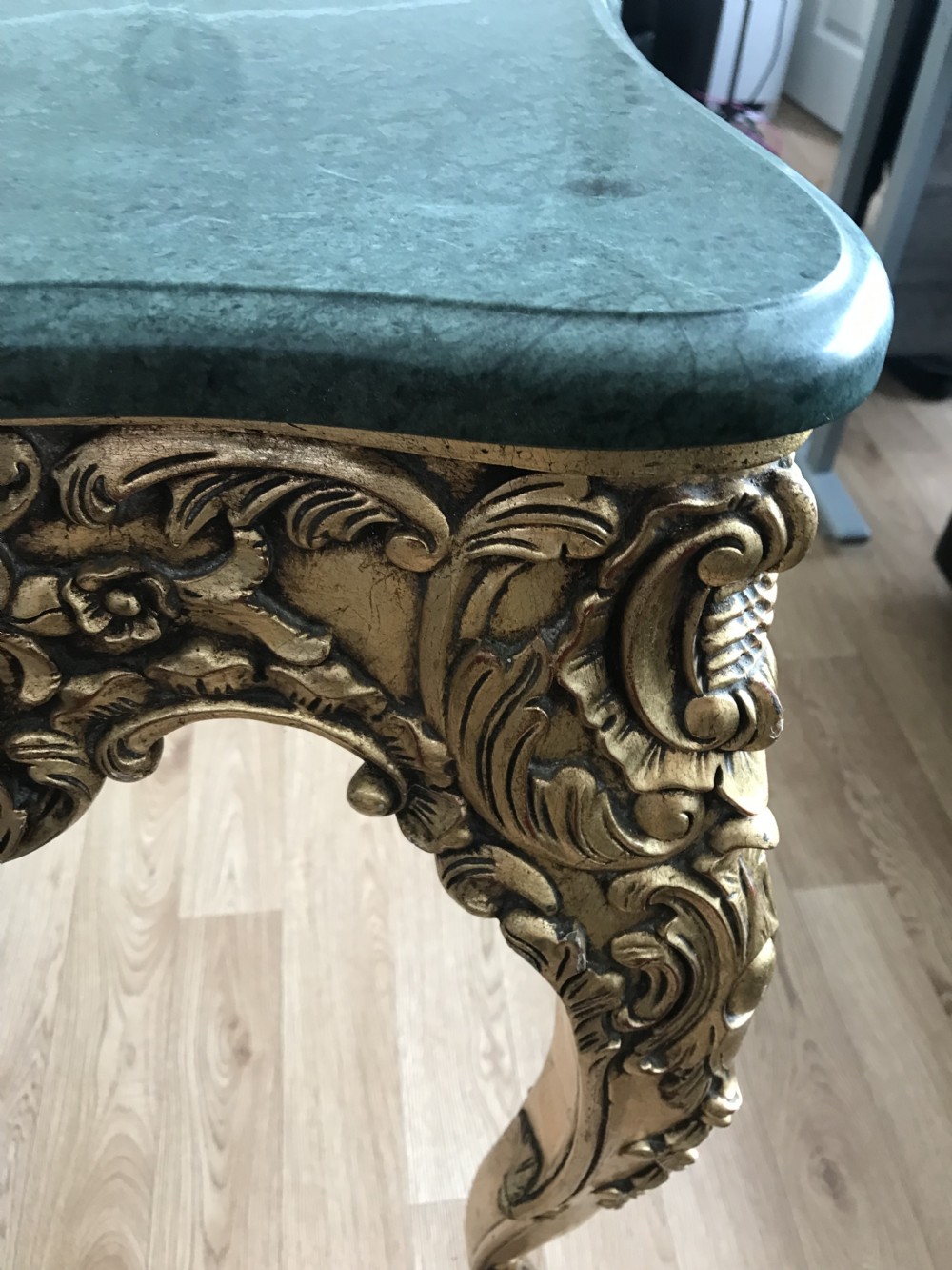 A French Rococo Revival style occasional table with a serpentine green marble top supported by an ornate gilded frame with carved cabriole legs. View XXI