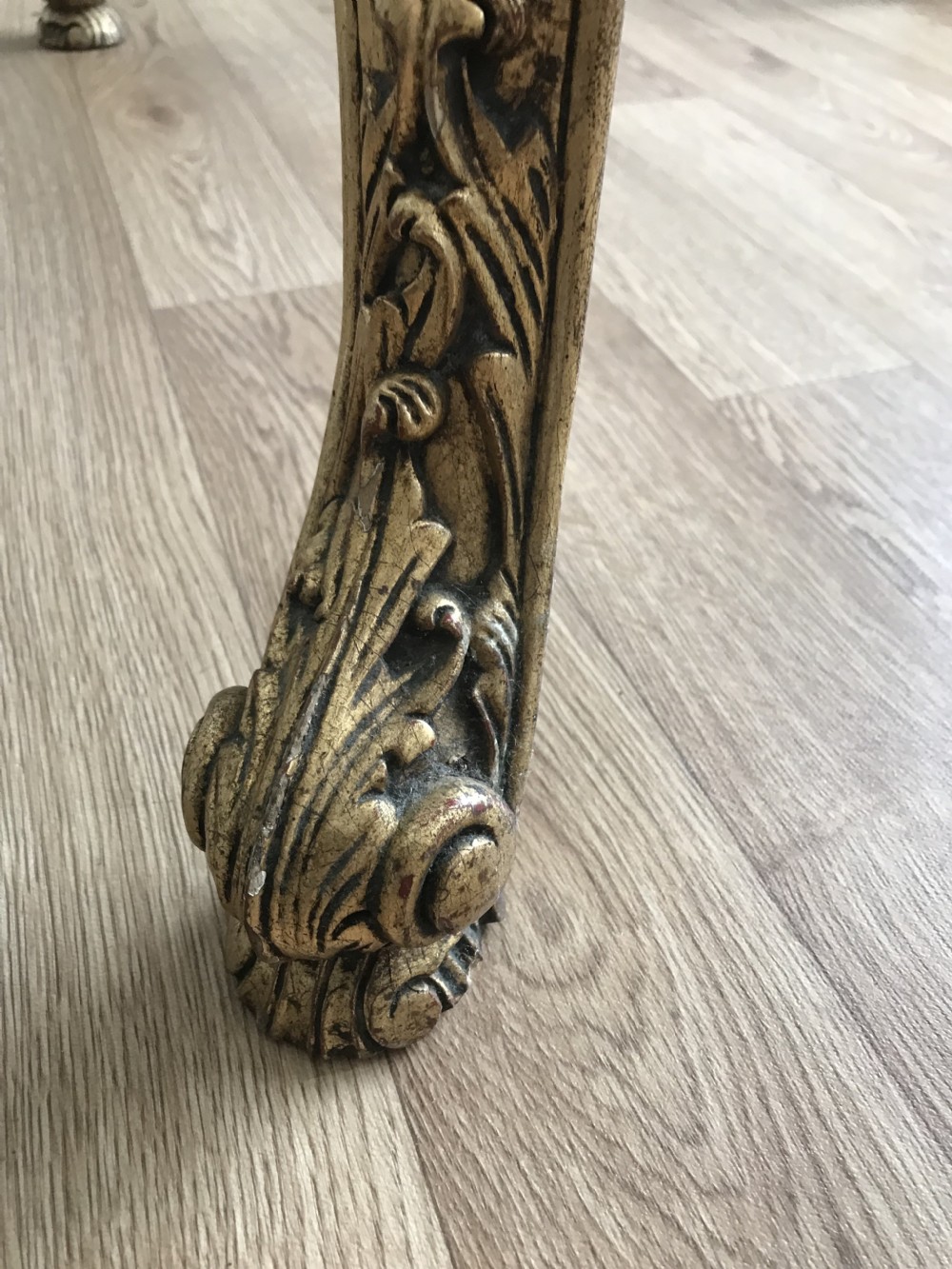 A French Rococo Revival style occasional table with a serpentine green marble top supported by an ornate gilded frame with carved cabriole legs. View XXIII
