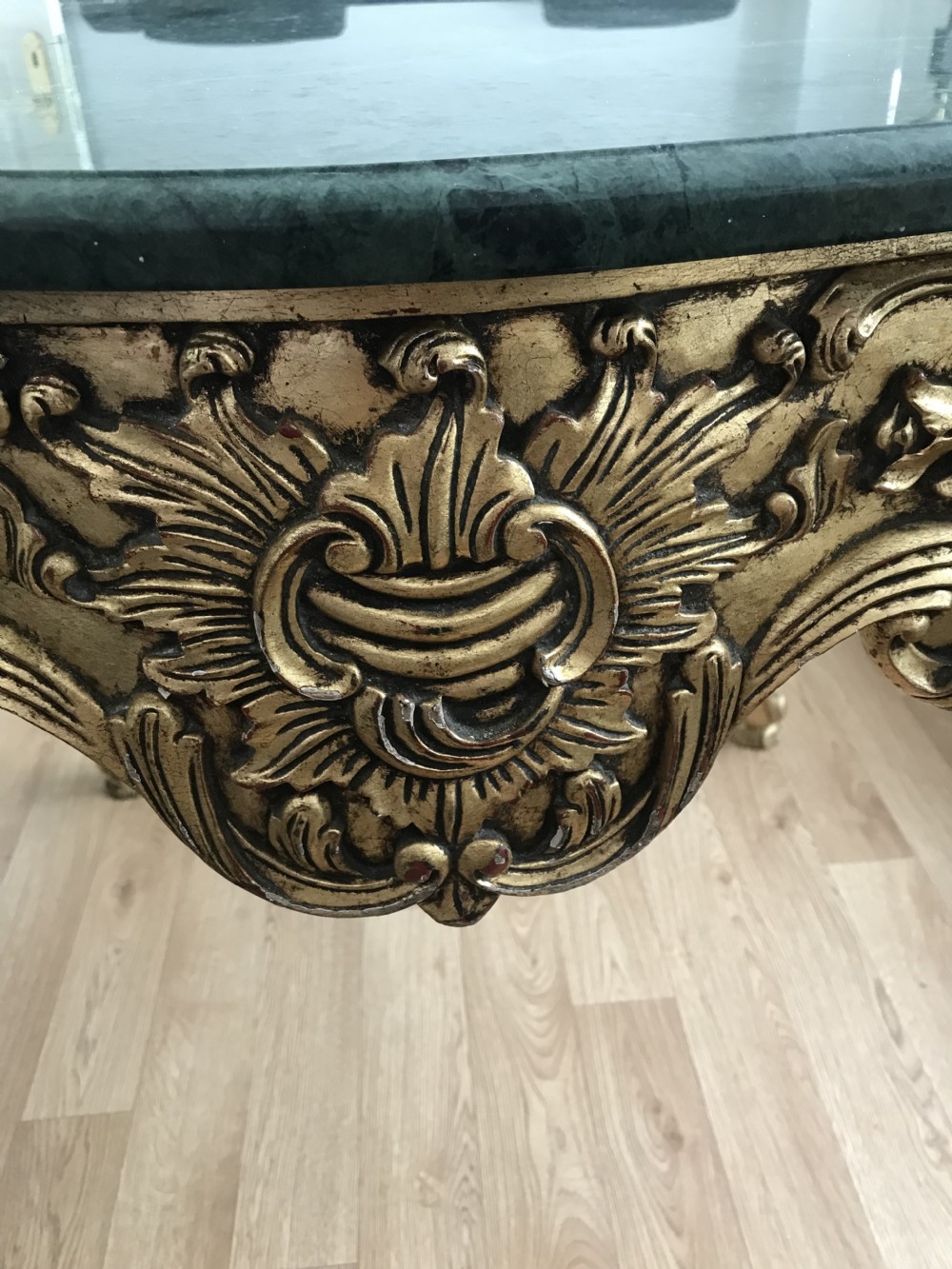 A French Rococo Revival style occasional table with a serpentine green marble top supported by an ornate gilded frame with carved cabriole legs. View XXV